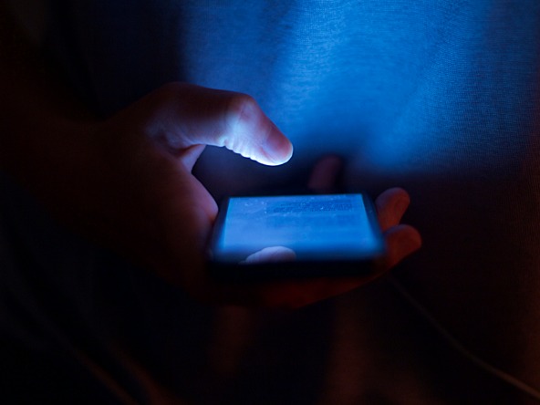 person using mobile phone in the dark